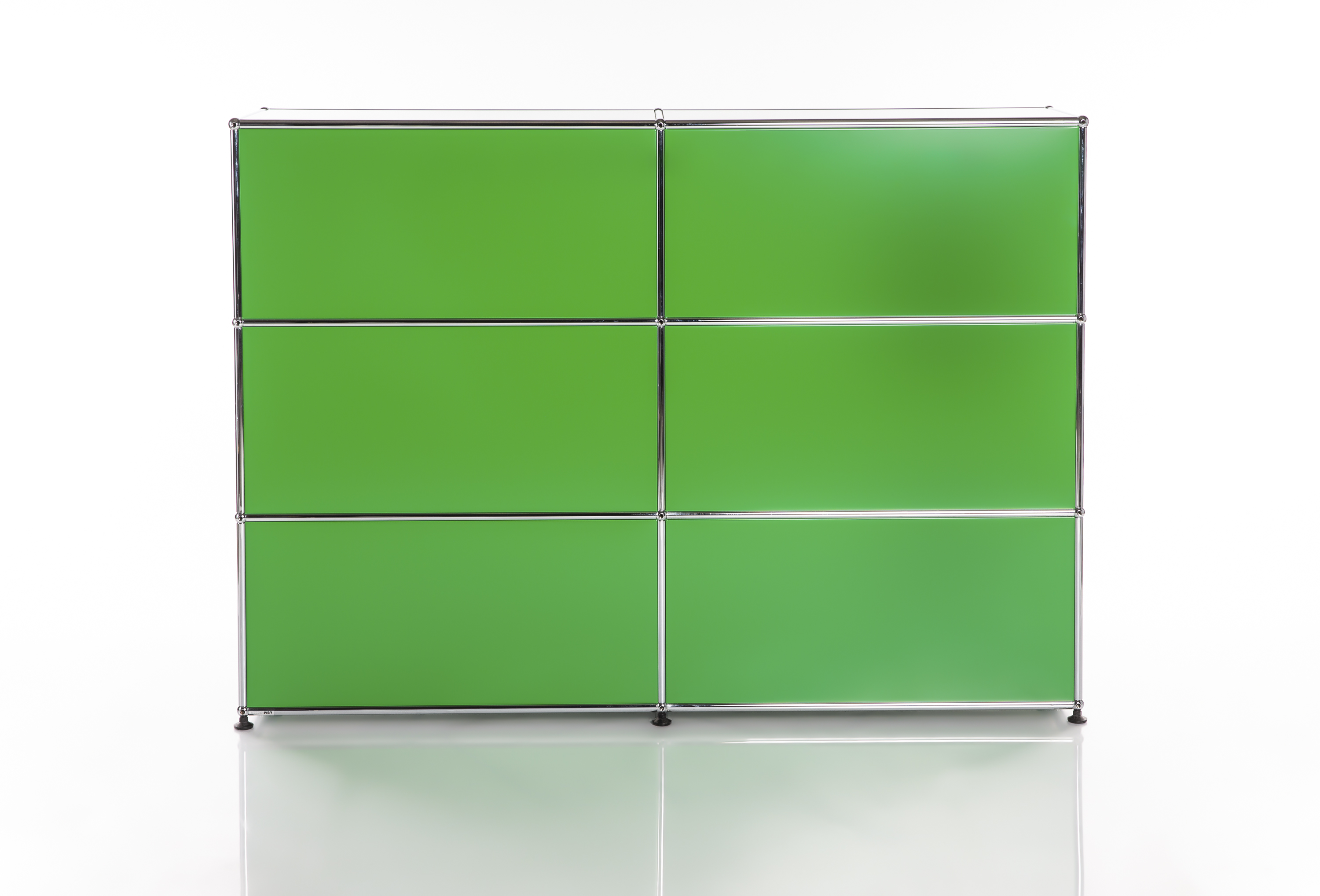 A modern, modular shelving unit in bright green with a chrome frame, comprising six compartments arranged in three rows and two columns. It stands on a glossy white base with a reflective finish, set against a plain, light-coloured background.