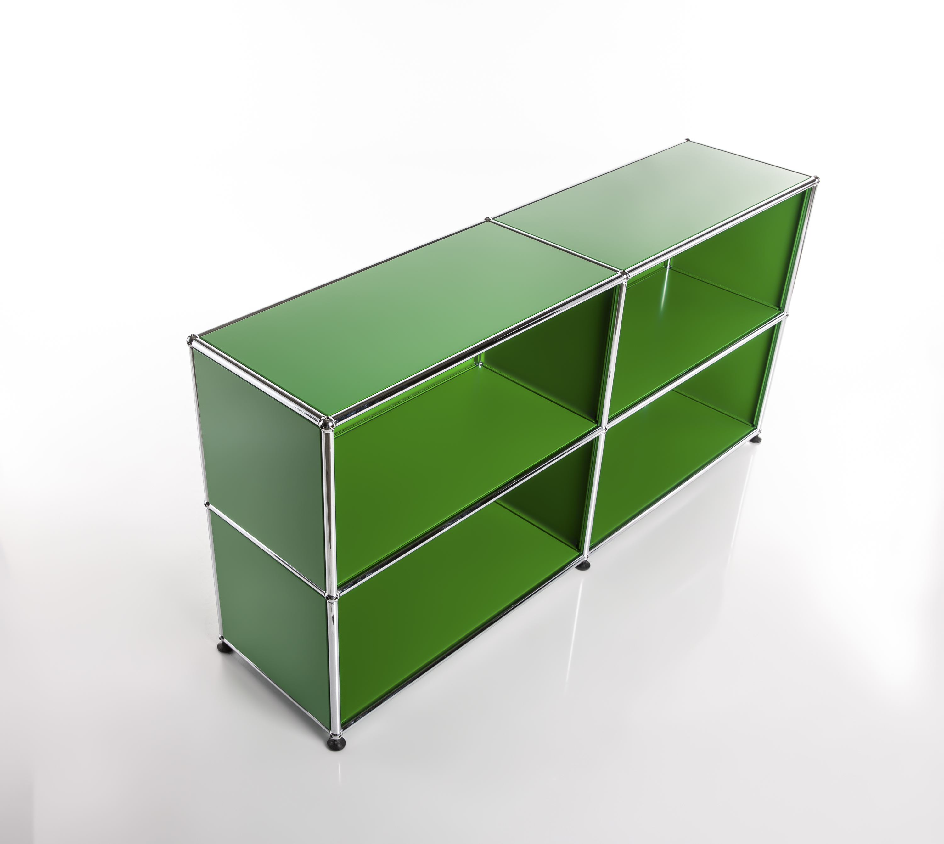 A modern, modular shelving unit in a vibrant green with four square compartments. Glossy green panels set within a slim silver metal frame, resting on small black feet. Set against a light background with a subtle mirror-like sheen.