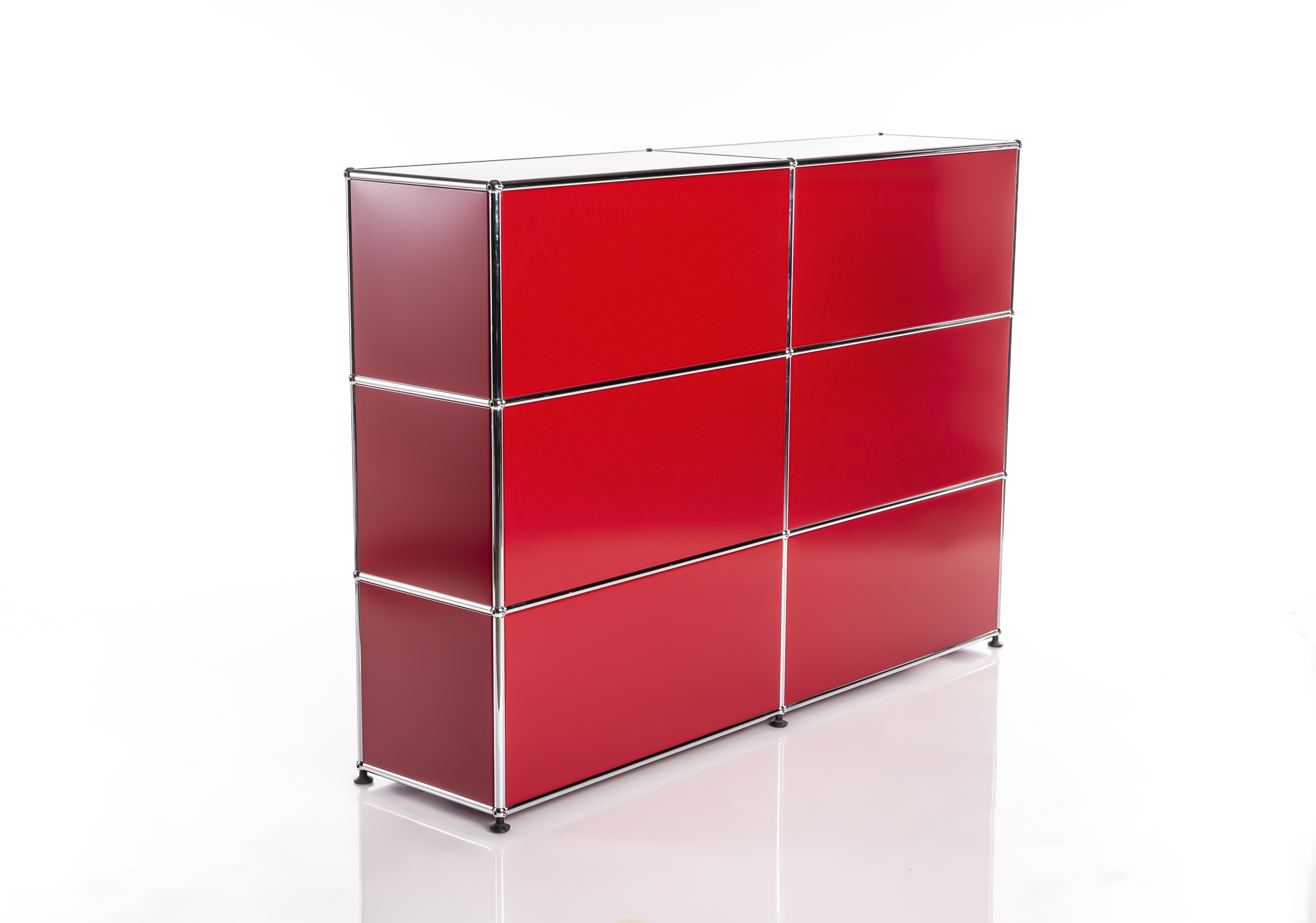 High-gloss modular cabinet in bright red with silver chrome frames against a white background. 3x3 grid with nine compartments. The smooth surface reflects light; the left-hand panels appear darker. Black feet, slight reflection.